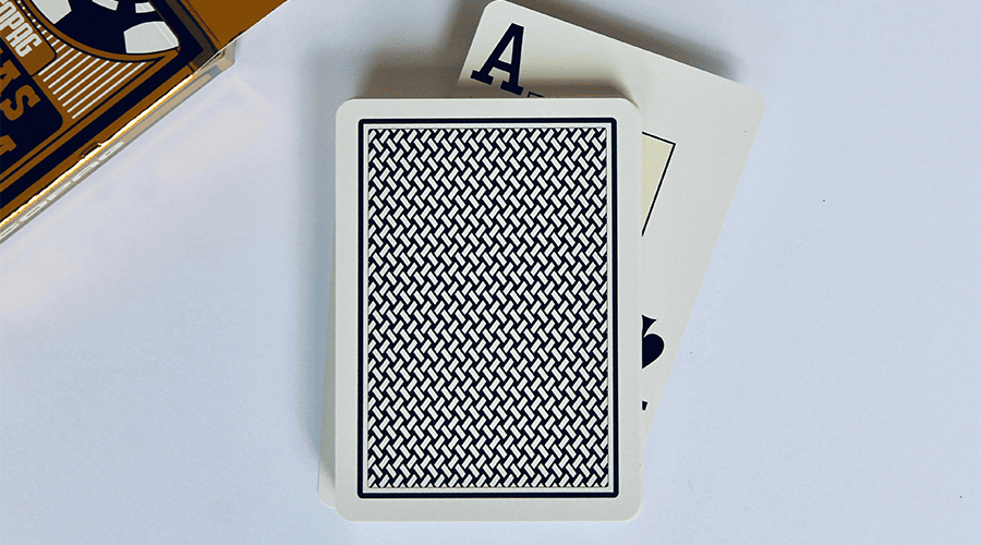 A deck of playing cards for wedding hampers on top of a white counter and the card pack on the left side and the ace card sticking out of the deck.